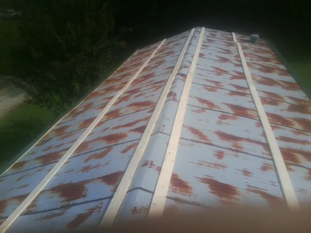 Rusted metal roof panels with new wood purlins before replacement — Storm Damage Roof Repair in Milroy by Roofing Brothers